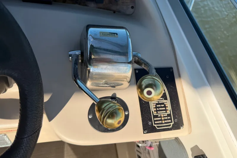 Slide: The Image of Throttle controls on a 2002 Sea Ray 340 Sundancer boat dashboard. - 15