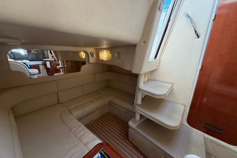 Slide: The Image of Interior of 2002 Sea Ray 340 Sundancer yacht, featuring cozy seating and elegant design. - 37