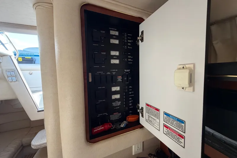 Slide: The Image of Electrical panel inside a 2002 Sea Ray 340 Sundancer boat, with open cabinet door. - 43