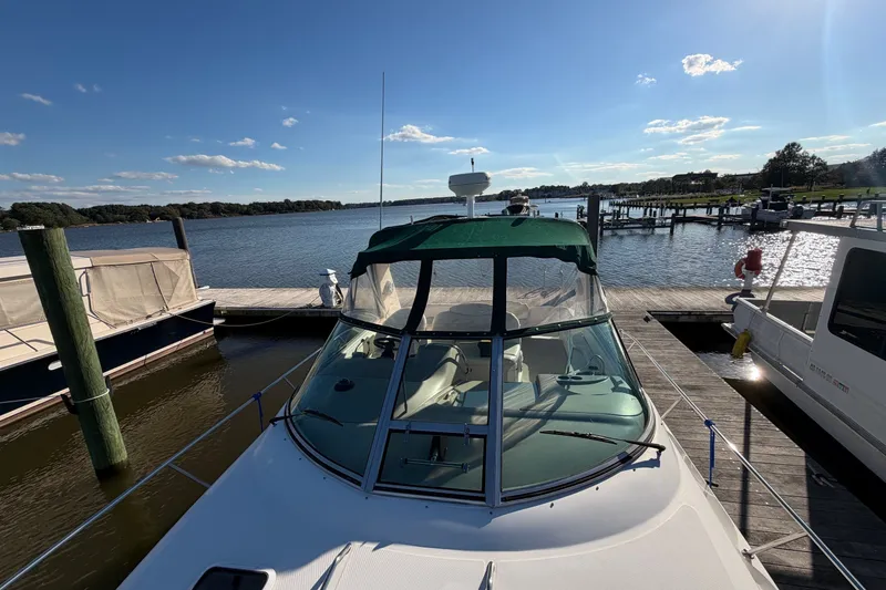 Slide: The Image of 2002 Sea Ray 340 Sundancer docked at a marina under a clear blue sky. - 9