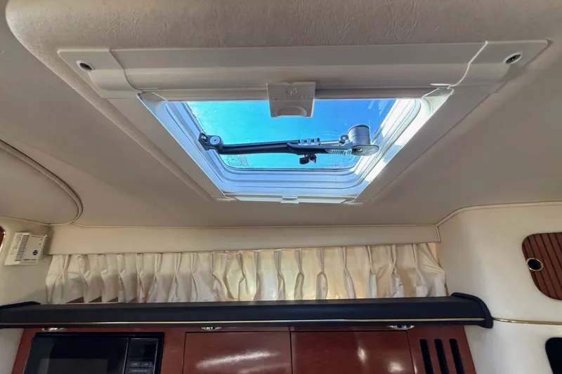 Slide: The Image of Interior view of 2002 Sea Ray 340 Sundancer cabin with skylight and curtains. - 45