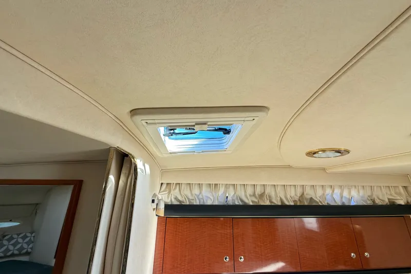 Slide: The Image of Interior ceiling of 2002 Sea Ray 340 Sundancer with skylight and wooden cabinets. - 47