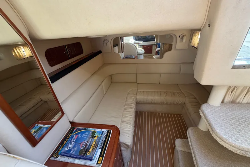 Slide: The Image of Interior of 2002 Sea Ray 340 Sundancer yacht with beige seating and wooden accents. - 36