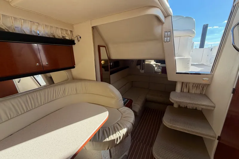 Slide: The Image of Interior of 2002 Sea Ray 340 Sundancer yacht with plush seating and elegant cabinetry. - 27