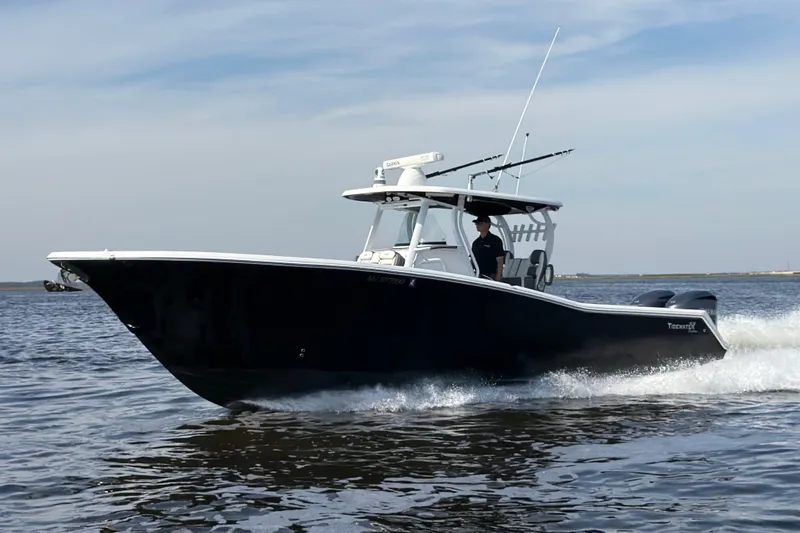 The Image of 2017 Tidewater 320 CC Adventure boat cruising on open water. - 1