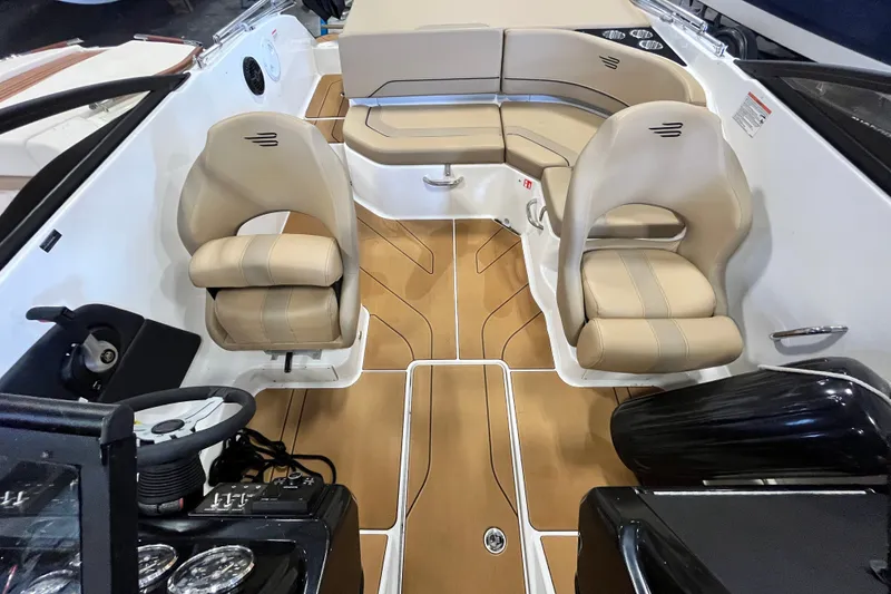 Slide: The Image of 2025 Bayliner V20i boat interior with beige seating and modern dashboard. - 8