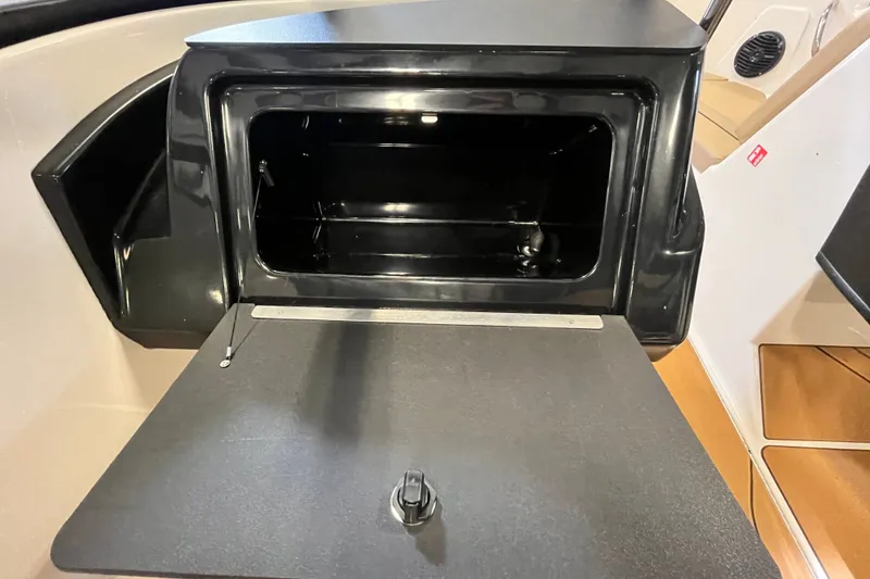 Slide: The Image of Open storage compartment in 2025 Bayliner V20i boat interior. - 12
