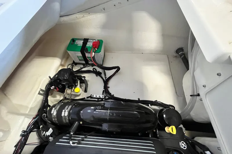 Slide: The Image of 2025 Bayliner V20i engine compartment with battery and wiring. - 17