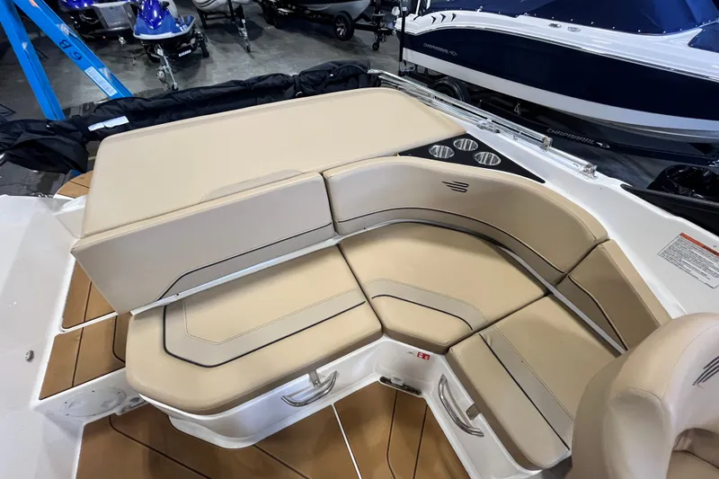Slide: The Image of 2025 Bayliner V20i boat interior with beige seating and cup holders. - 13