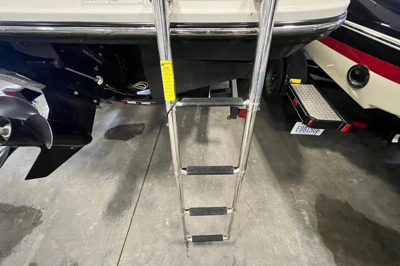 Slide: The Image of 2025 Bayliner V20i boat with ladder and propeller in a showroom. - 19
