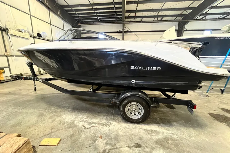 Slide: The Image of 2025 Bayliner V20i boat on trailer in indoor storage facility. - 1