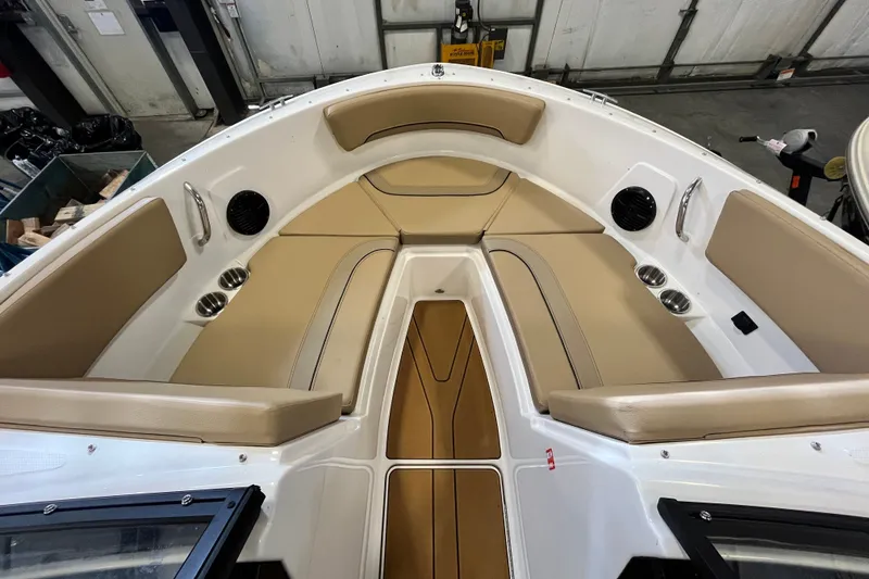 Slide: The Image of 2025 Bayliner V20i boat interior with tan seating and cup holders. - 7