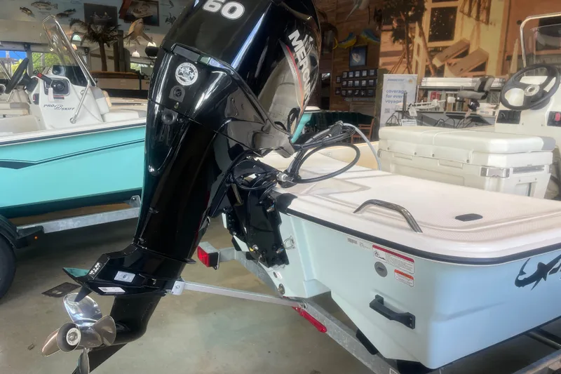 Slide: The Image of 2026 Mako Pro Skiff 15 CC with Mercury 60 outboard motor in showroom. - 5