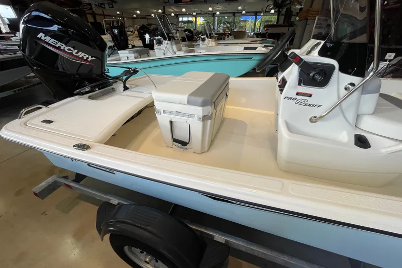Slide: The Image of 2026 Mako Pro Skiff 15 CC boat with Mercury engine in showroom display. - 4