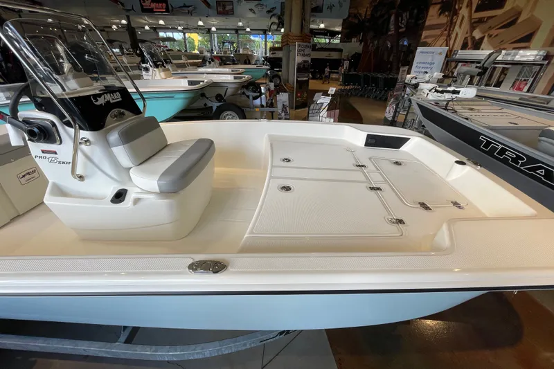 Slide: The Image of 2026 Mako Pro Skiff 15 CC boat interior with seating and storage compartments. - 3