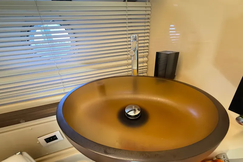 Slide: The Image of Luxurious bathroom sink on 2015 Azimut 54 yacht with modern design and window blinds. - 96