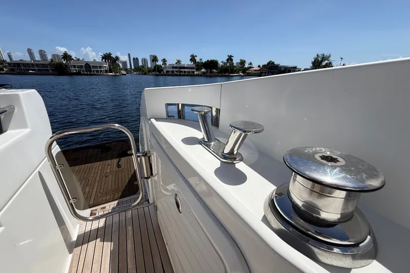 Slide: The Image of Azimut 54 yacht deck view, showcasing sleek design and waterfront scenery, 2015 model. - 51