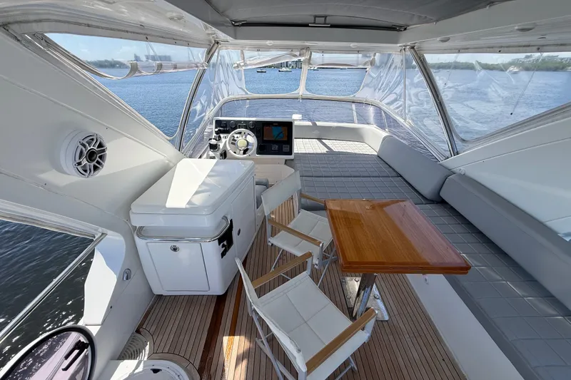 Slide: The Image of Luxurious 2015 Azimut 54 yacht interior with helm, seating, and wooden table. - 24
