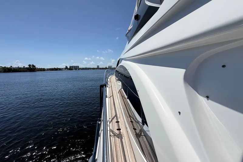 Slide: The Image of Side view of 2015 Azimut 54 yacht on calm water under clear blue sky. - 22