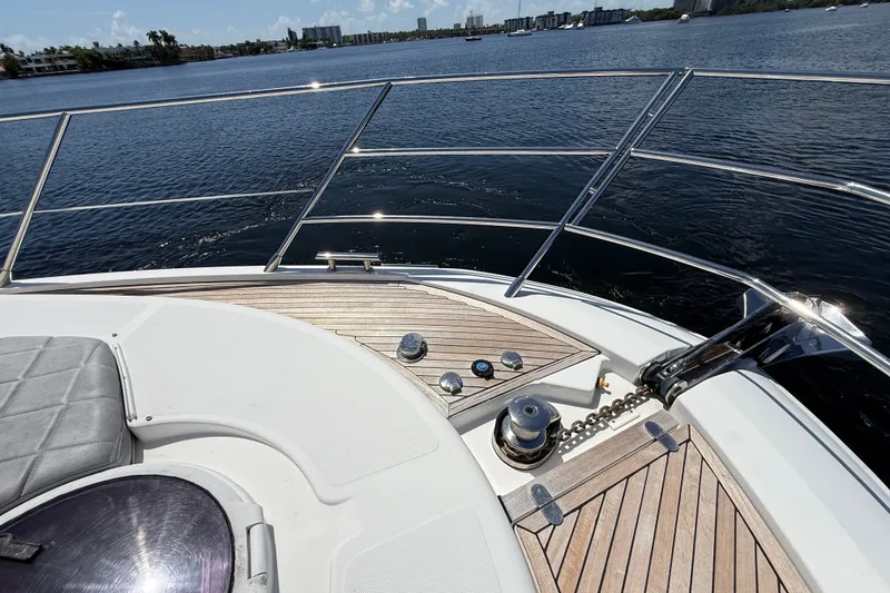 Slide: The Image of Bow view of 2015 Azimut 54 yacht with teak decking and scenic waterfront. - 19