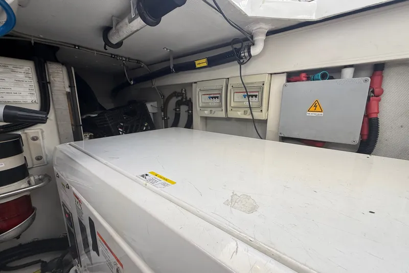 Slide: The Image of Engine room of a 2015 Azimut 54 yacht, featuring electrical panels and equipment. - 111