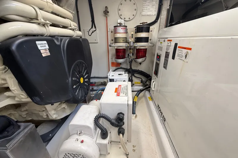 Slide: The Image of Engine room of a 2015 Azimut 54 yacht, featuring Kohler generator and fuel filters. - 104