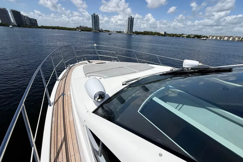 Slide: The Image of 2015 Azimut 54 yacht on calm water with city skyline in background. - 20