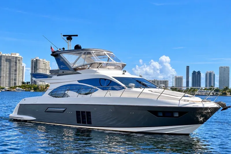 The Image of Luxury 2015 Azimut 54 yacht cruising near city skyline on a sunny day. - 0