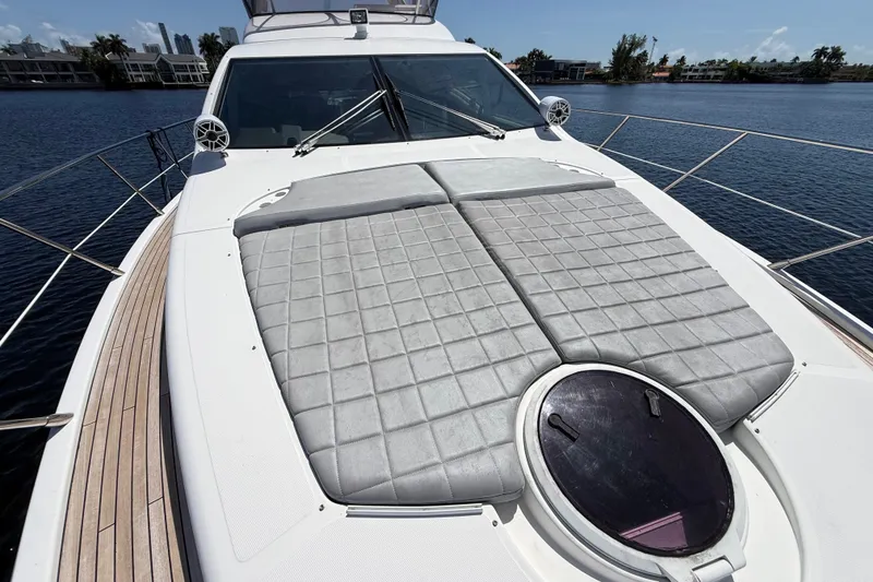 Slide: The Image of Luxury 2015 Azimut 54 yacht with sunbathing deck, docked on calm waters. - 15