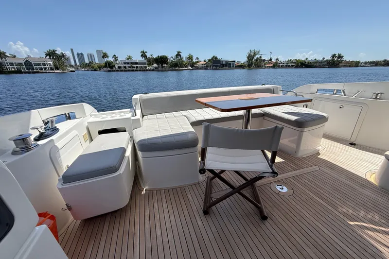 Slide: The Image of Luxurious 2015 Azimut 54 yacht deck with seating and scenic waterfront view. - 58