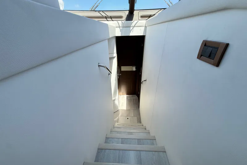 Slide: The Image of Staircase leading to interior of 2015 Azimut 54 yacht, featuring sleek design. - 80