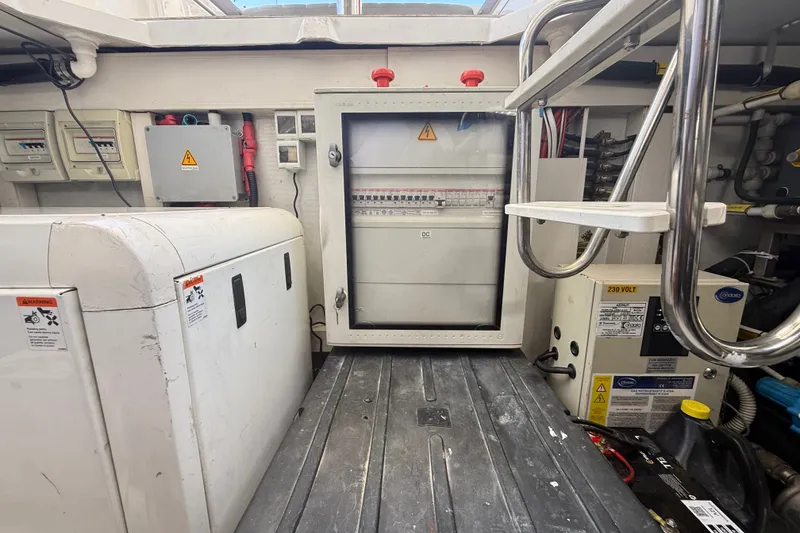 Slide: The Image of Engine room of a 2015 Azimut 54 yacht, featuring electrical panels and equipment. - 115