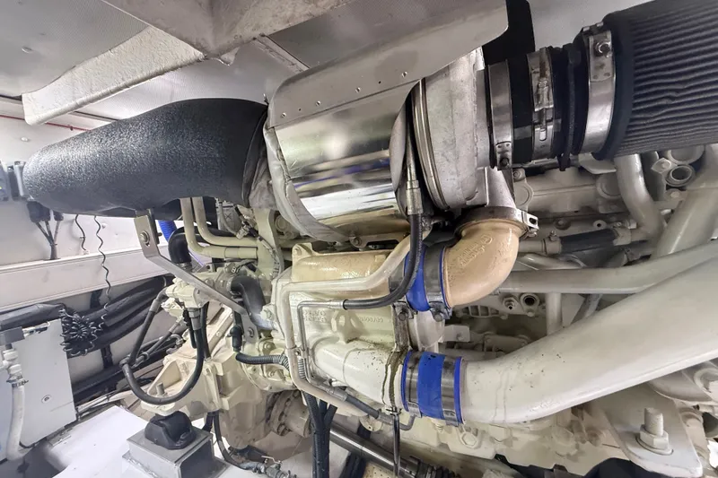 Slide: The Image of Engine compartment of a 2015 Azimut 54 yacht, showcasing mechanical components and piping. - 112