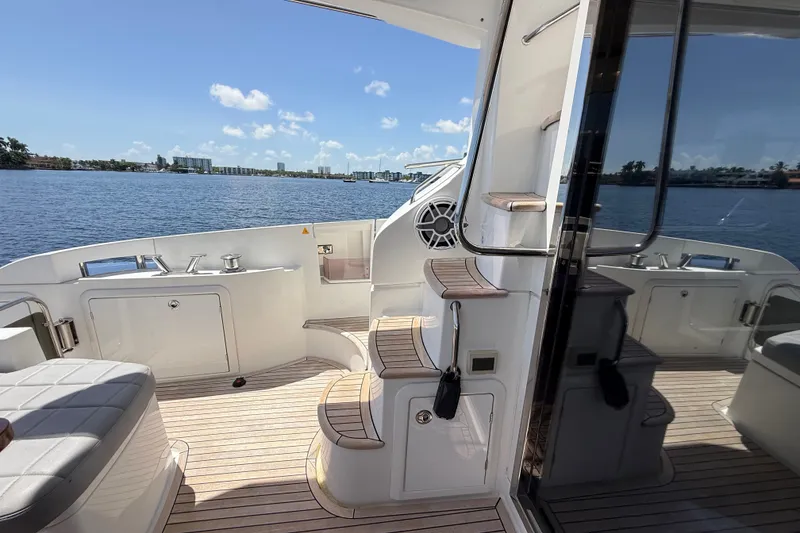 Slide: The Image of Luxurious 2015 Azimut 54 yacht deck with elegant seating and scenic water view. - 56