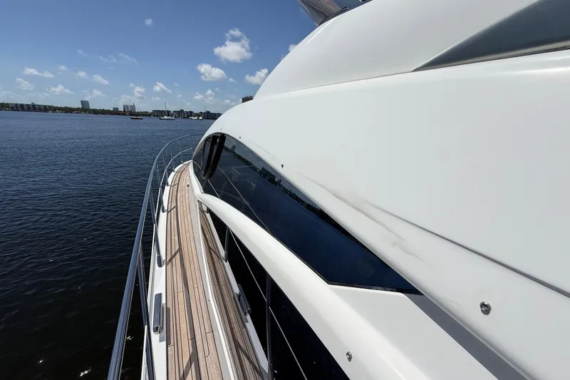 Slide: The Image of 2015 Azimut 54 yacht cruising on calm waters under a clear blue sky. - 21