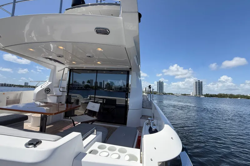 Slide: The Image of 2015 Azimut 54 yacht on water, featuring sleek design and luxurious deck area. - 50