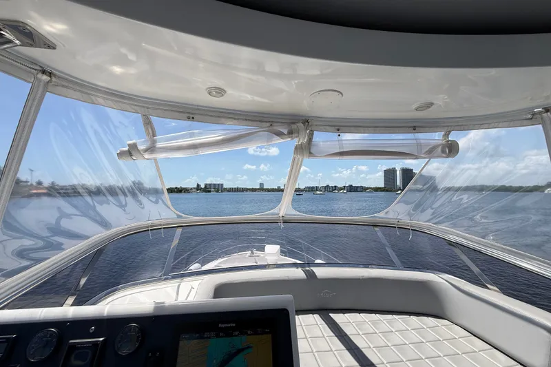 Slide: The Image of View from the helm of a 2015 Azimut 54 yacht, overlooking calm waters and distant skyline. - 33