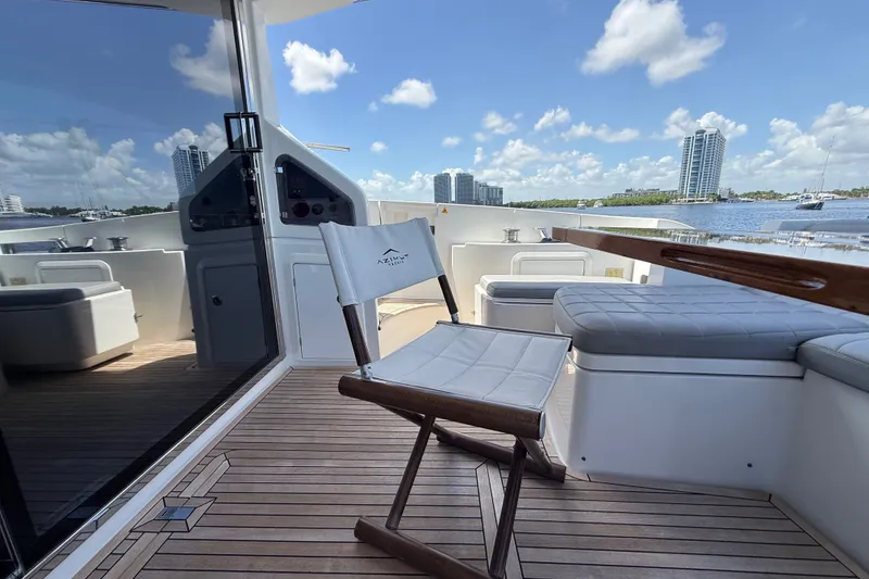 Slide: The Image of Luxurious 2015 Azimut 54 yacht deck with seating, overlooking waterfront skyline. - 61
