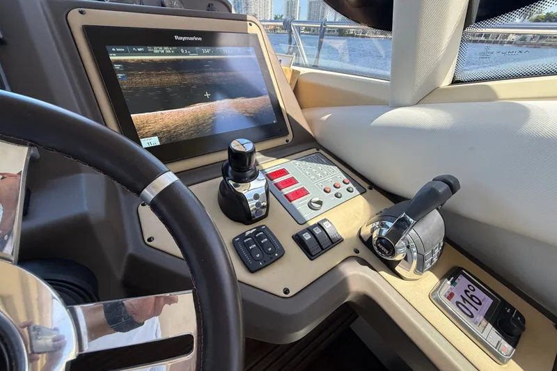 Slide: The Image of Cockpit of 2015 Azimut 54 yacht with navigation controls and display screen. - 78