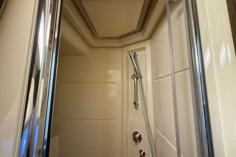 Slide: The Image of Shower area inside a 2015 Azimut 54 yacht, featuring sleek chrome fixtures. - 95