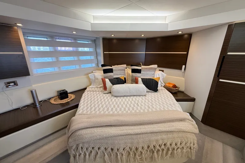 Slide: The Image of Luxurious bedroom interior of a 2015 Azimut 54 yacht, featuring elegant bedding and modern design. - 87