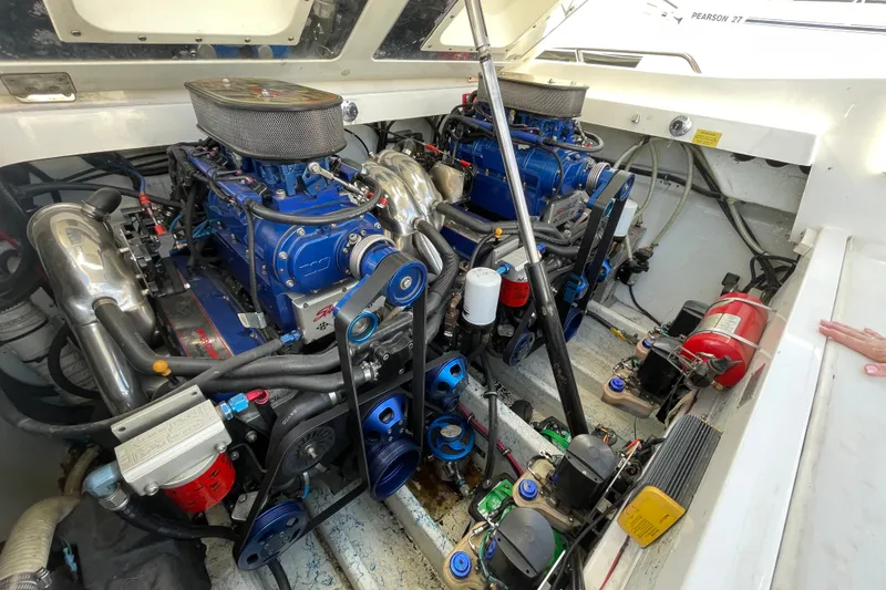 Slide: The Image of Engine compartment of a 2002 Fountain 35 Lightning boat, showcasing dual high-performance engines. - 5