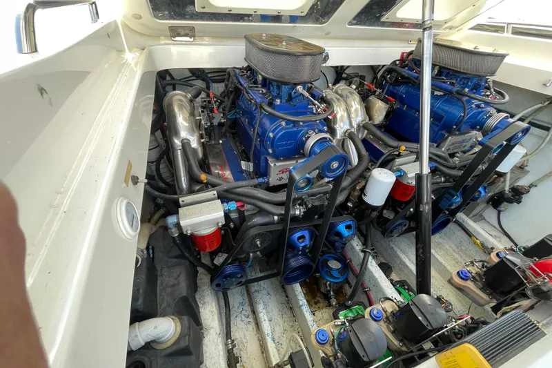 Slide: The Image of Engine compartment of a 2002 Fountain 35 Lightning boat, showcasing dual high-performance engines. - 6