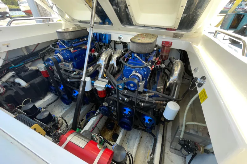 Slide: The Image of Engine compartment of a 2002 Fountain 35 Lightning boat, showcasing dual high-performance engines. - 10