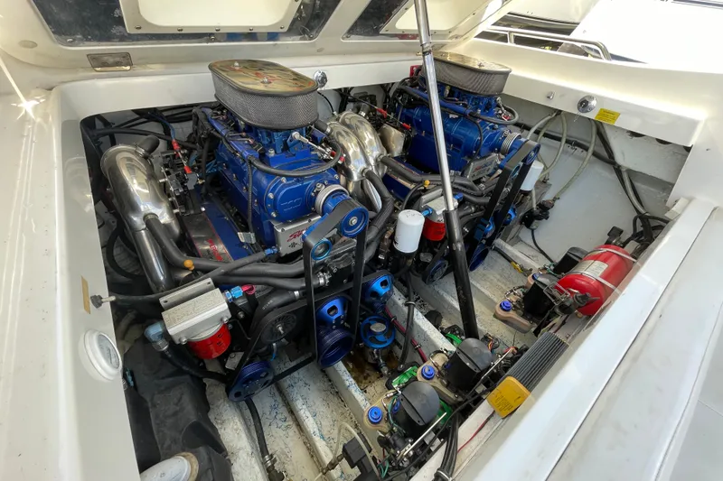 Slide: The Image of Engine compartment of a 2002 Fountain 35 Lightning boat, showcasing dual high-performance engines. - 8