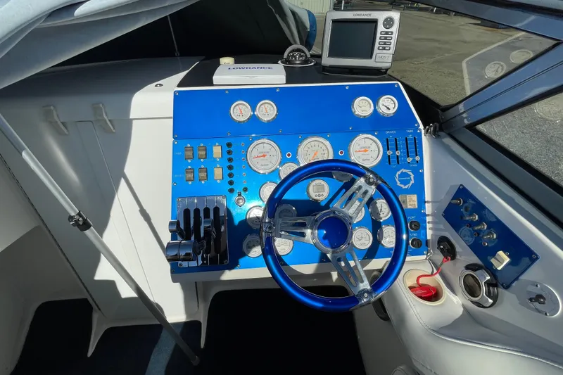 Slide: The Image of Cockpit of 2002 Fountain 35 Lightning boat with blue dashboard and steering wheel. - 24