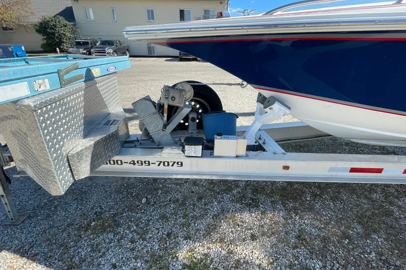 Slide: The Image of 2002 Fountain 35 Lightning boat on trailer, featuring blue hull and diamond plate toolbox. - 34