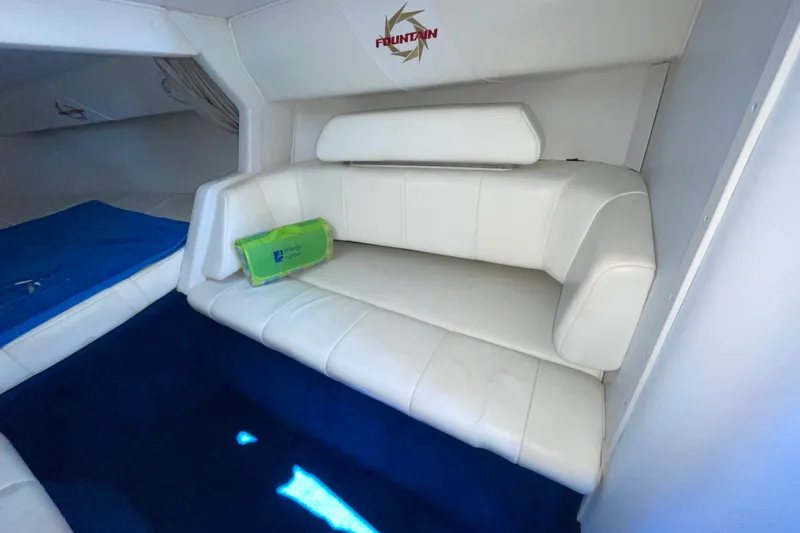 Slide: The Image of Interior of 2002 Fountain 35 Lightning boat with white seating and blue carpet. - 28