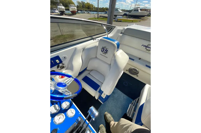 Slide: The Image of Interior of a 2002 Fountain 35 Lightning boat with blue and white seating. - 21