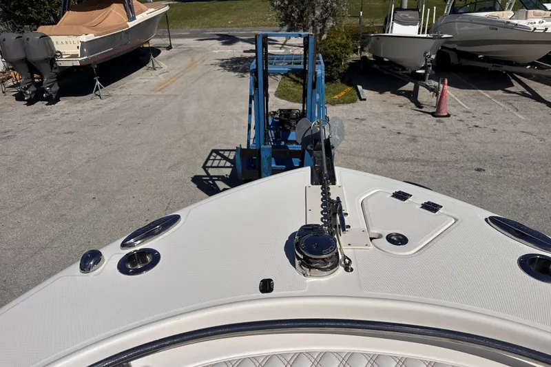 Slide: The Image of 2017 Robalo R242 Center Console boat on trailer, marina background. - 18